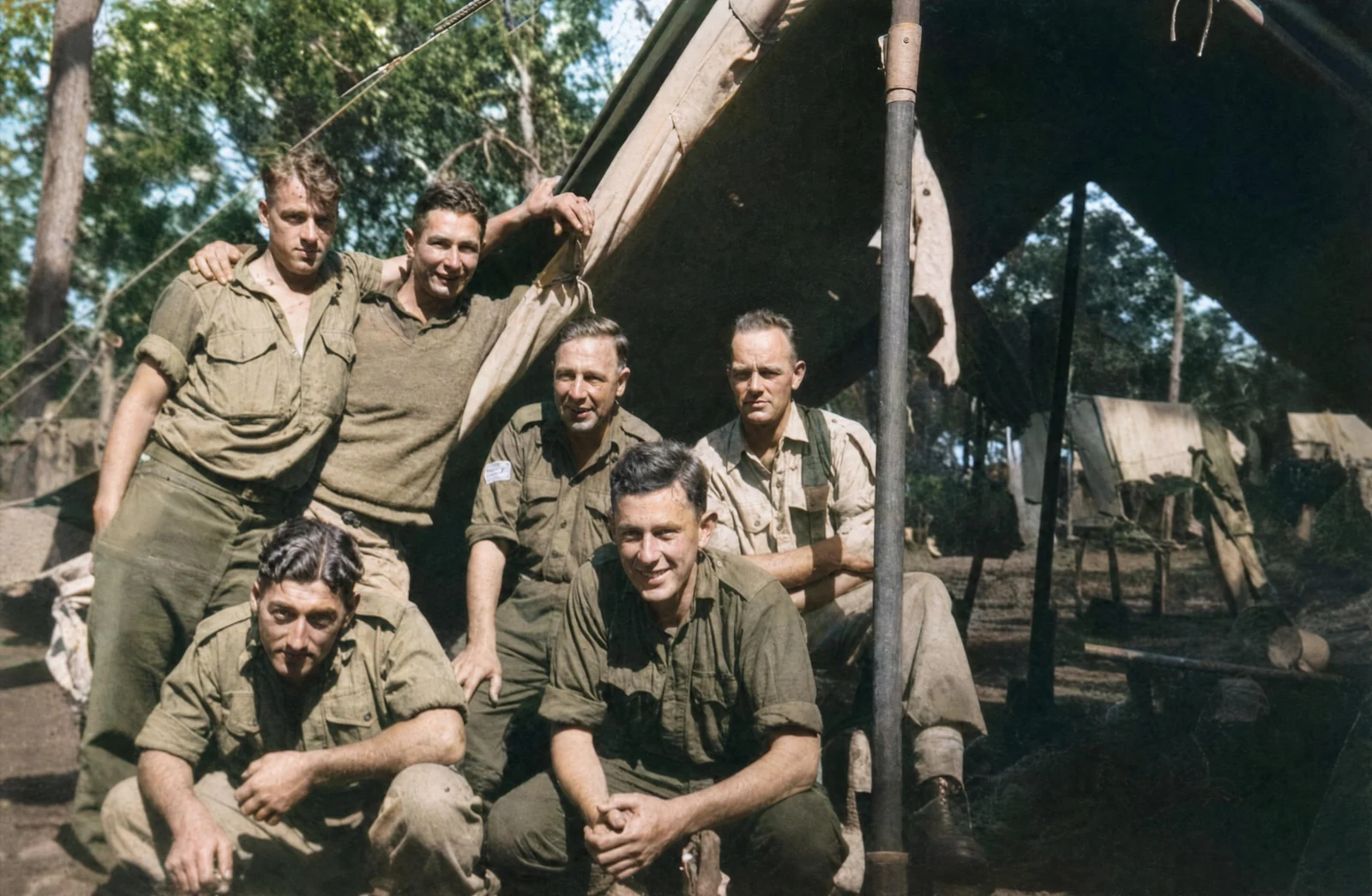 AI-colourised photograph of the same WWII-era soldiers — natural skin tones, accurate uniform colours, period-appropriate scene